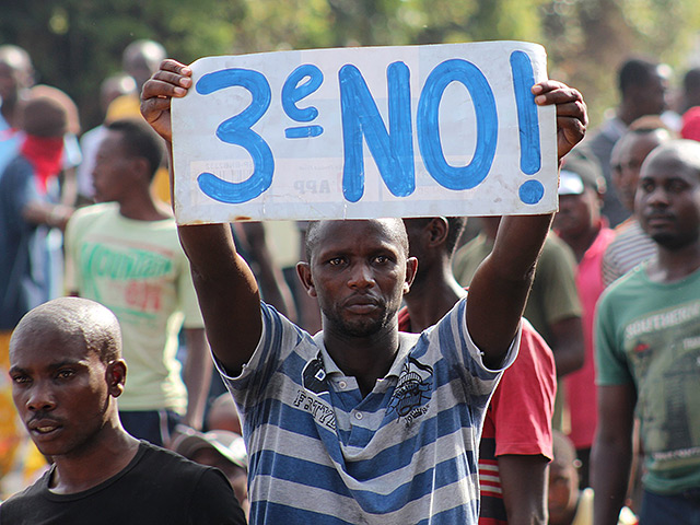 A protester holds a placard as they demonstrate against the ruling CNDD-FDD party's decision to allow Burundian President Pierre Nkurunziza to run for a third five-year term in office, in Bujumbura, May 4, 2015. Two protesters were killed on Monday as demonstrations against Nkurunziza's decision to seek a third term in office ran into a second week, a leading rights activist said. REUTERS/Jean Pierre Aime Harerimana