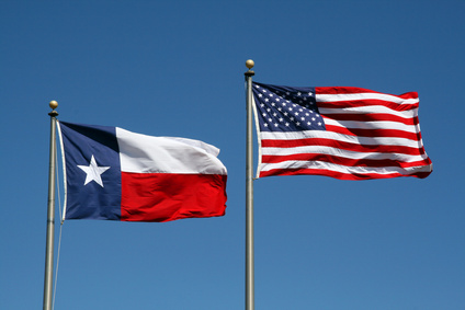 A Texas and US flag boldly flapping in the wind.